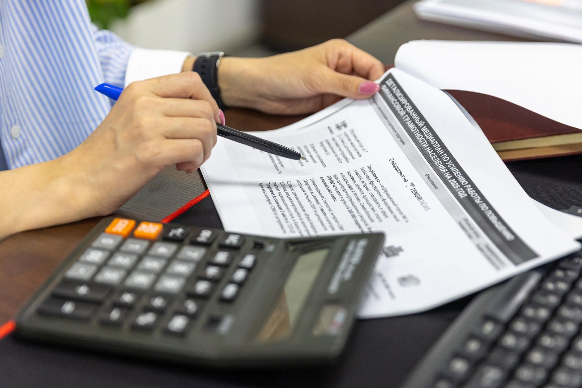 Senior financial audit professional examining spreadsheet anomalies